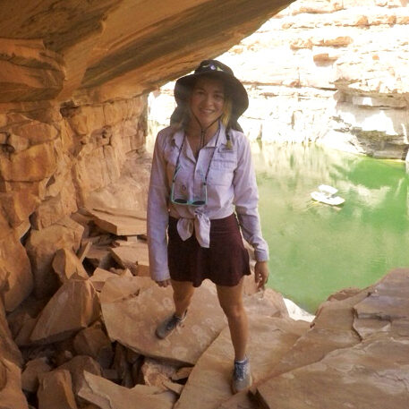 Emily Clements standing outside in a rock formation