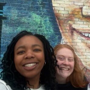 Makeda Grimaud, left, and Natalie Sheridan in front of Nat King Cole mural.