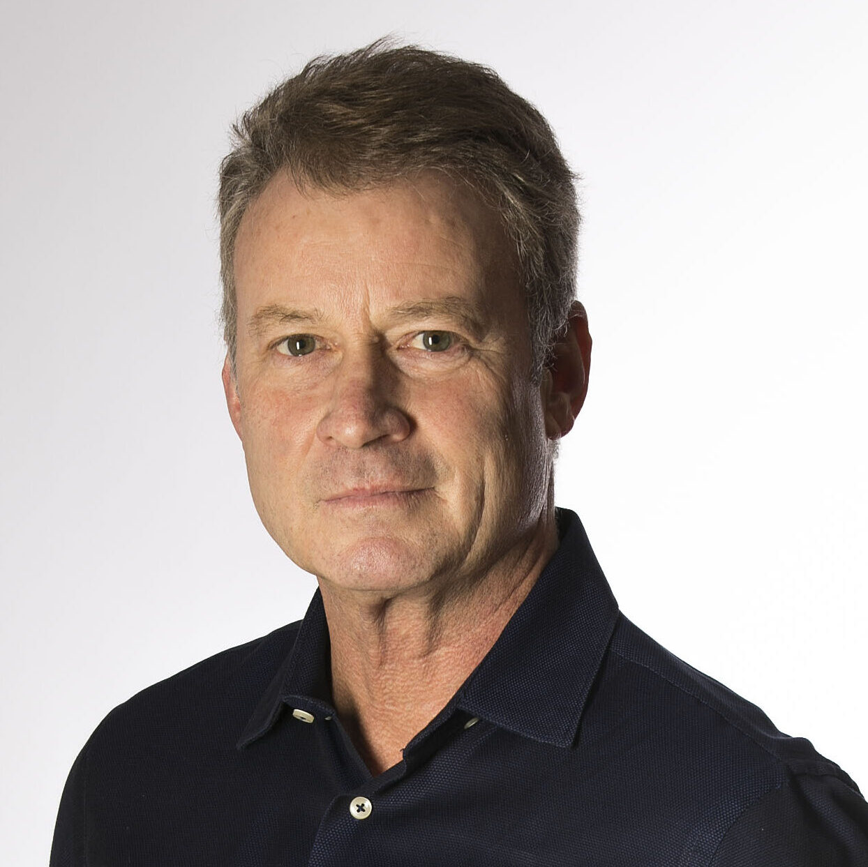 Portrait of Timothy Egan, a Caucasian male with short hair, wearing a black button front shirt
