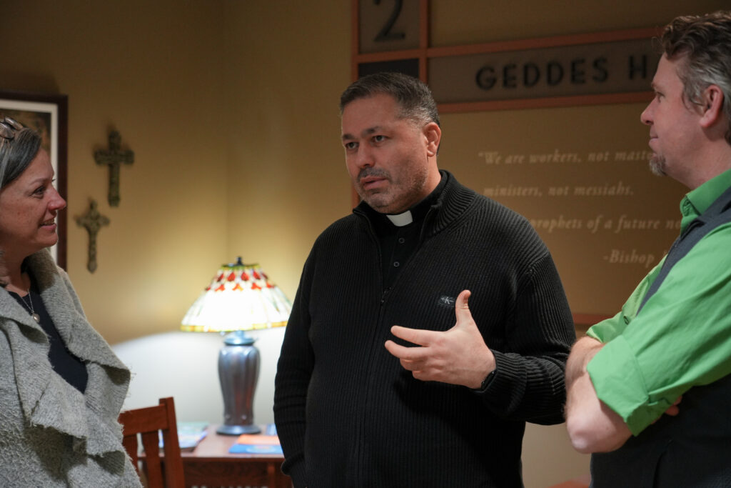 Rev. Yuriy Shchurko, center, at the Institute for Social Concerns, with Felicia Johnson O'Brien and Ryan Juskus