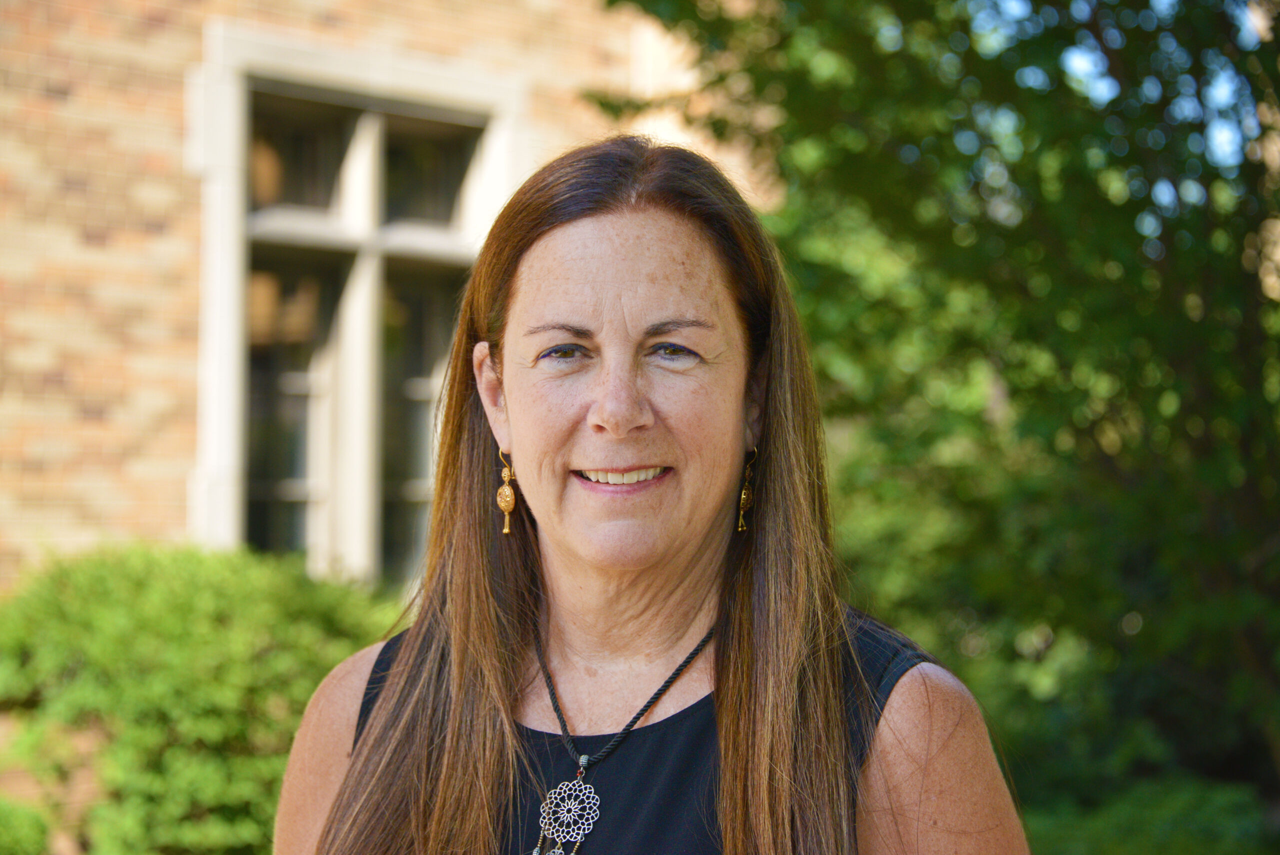 Suzanne Shanahan stands in front of Geddes Hall