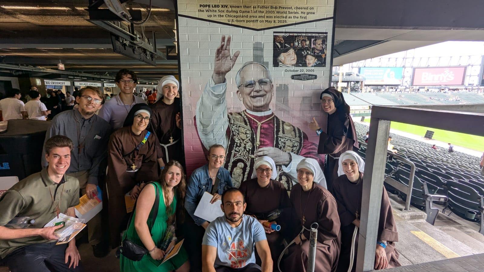 Students with Catholic sisters in Chicago with mural of Pope Leo XIV